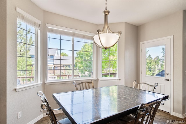 22227 E Hinsdale Ave, Aurora, CO 80016 - dining area with baseboards, dark wood-type flooring, and a textured wall