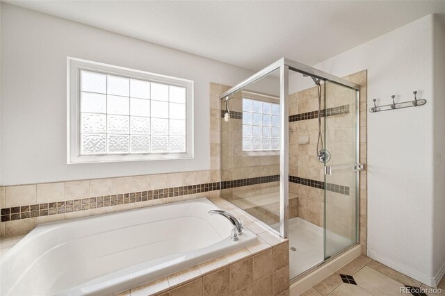 22227 E Hinsdale Ave, Aurora, CO 80016 - bathroom with a garden tub, a stall shower, and tile patterned floors