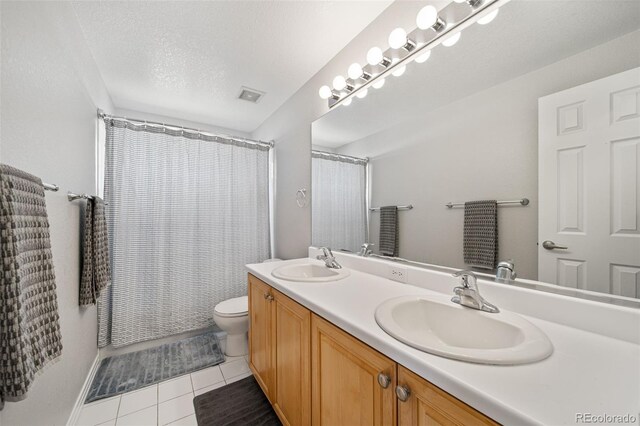 22227 E Hinsdale Ave, Aurora, CO 80016 - full bathroom featuring double vanity, toilet, tile patterned flooring, a shower with curtain, and a textured ceiling
