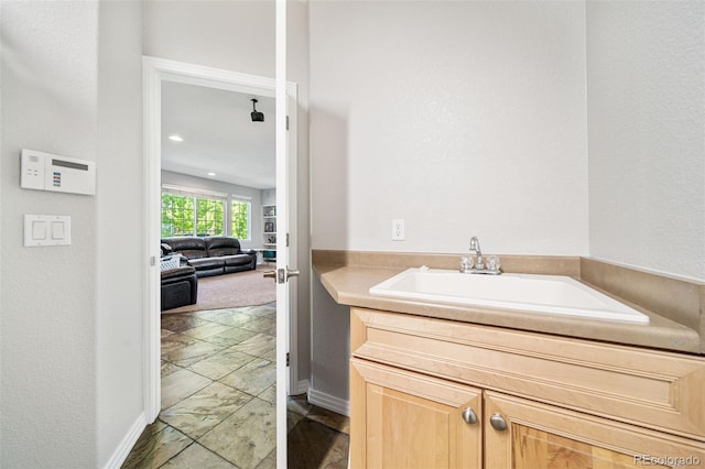 22227 E Hinsdale Ave, Aurora, CO 80016 - bathroom featuring baseboards and vanity