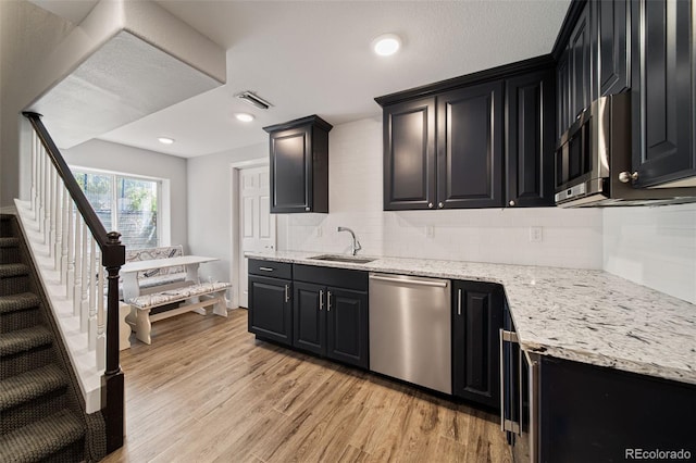 22227 E Hinsdale Ave, Aurora, CO 80016 - kitchen featuring appliances with stainless steel finishes, dark cabinets, backsplash, and recessed lighting