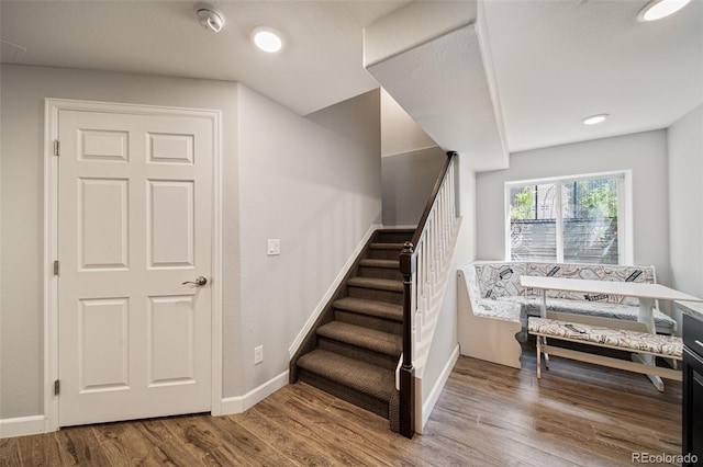 22227 E Hinsdale Ave, Aurora, CO 80016 - stairs featuring wood finished floors, baseboards, and recessed lighting