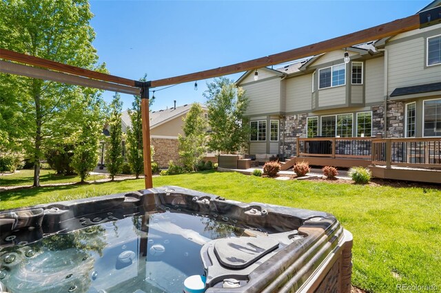 22227 E Hinsdale Ave, Aurora, CO 80016 - view of grassy yard with a deck and a hot tub