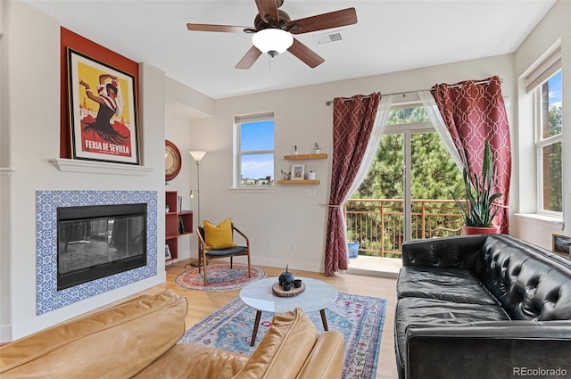 7828 W 54th Ave, Arvada, CO 80002 - living room with healthy amount of natural light, wood finished floors, and a fireplace