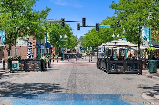 7828 W 54th Ave, Arvada, CO 80002 - view of asphalt street featuring traffic lights, street lighting, curbs, and sidewalks