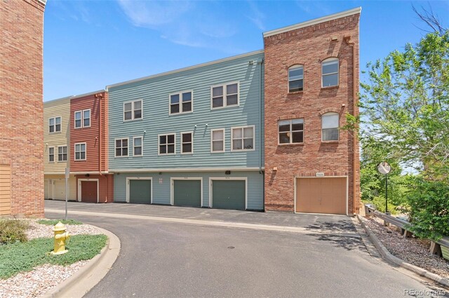 7828 W 54th Ave, Arvada, CO 80002 - view of property with an attached garage and driveway
