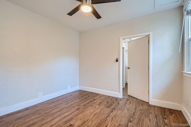 spare room with hardwood / wood-style flooring and ceiling fan