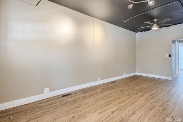 empty room with light wood-type flooring and ceiling fan