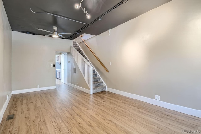 unfurnished living room with light wood-type flooring and ceiling fan