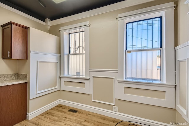 details with hardwood / wood-style flooring and ornamental molding