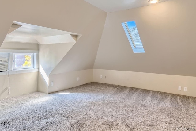 additional living space with carpet and vaulted ceiling with skylight