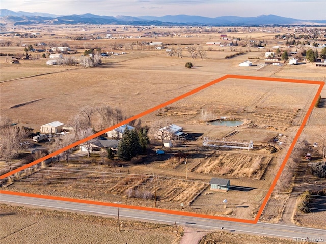 birds eye view of property featuring a mountain view and a rural view