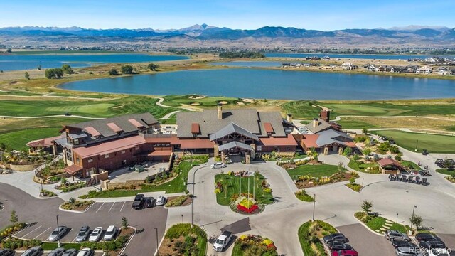 aerial view with golf course view and a water and mountain view