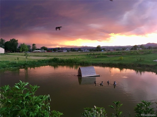 view of dock featuring a water and mountain view and a rural view