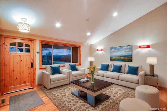 living area featuring visible vents, baseboards, vaulted ceiling, recessed lighting, and light wood-style floors