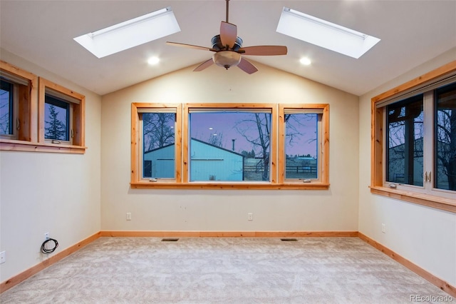 empty room with lofted ceiling, carpet flooring, and baseboards