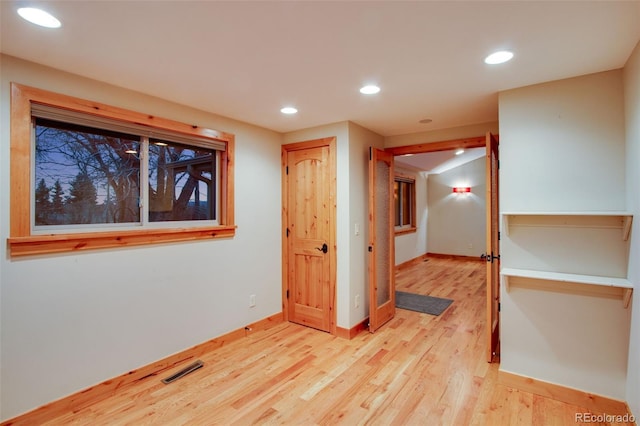 spare room with visible vents, recessed lighting, light wood-type flooring, and baseboards