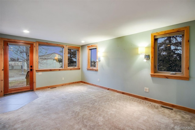 carpeted spare room featuring visible vents, recessed lighting, and baseboards