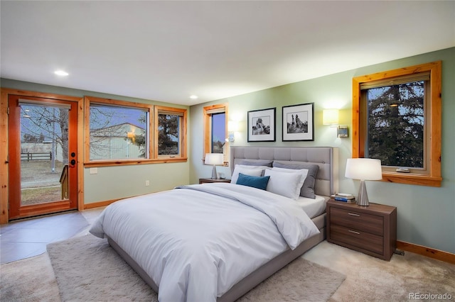 bedroom with access to exterior, recessed lighting, light carpet, and baseboards