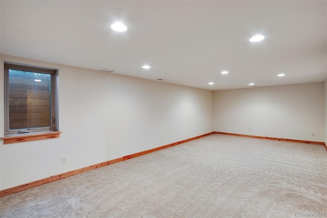 unfurnished room with recessed lighting, baseboards, and carpet