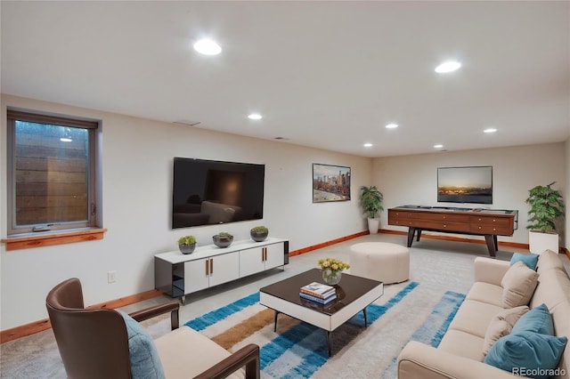 carpeted living room with recessed lighting and baseboards