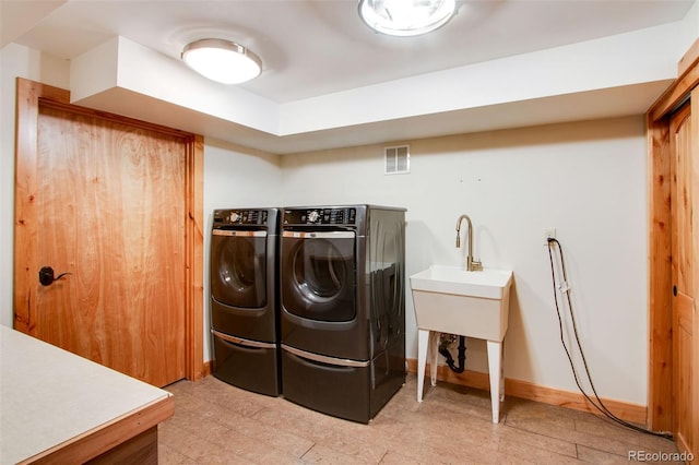 laundry room with visible vents, baseboards, light floors, laundry area, and washer and dryer