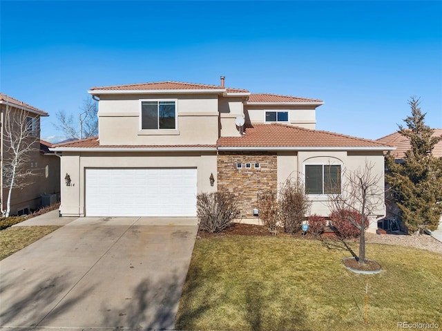 mediterranean / spanish home featuring a garage and a front lawn