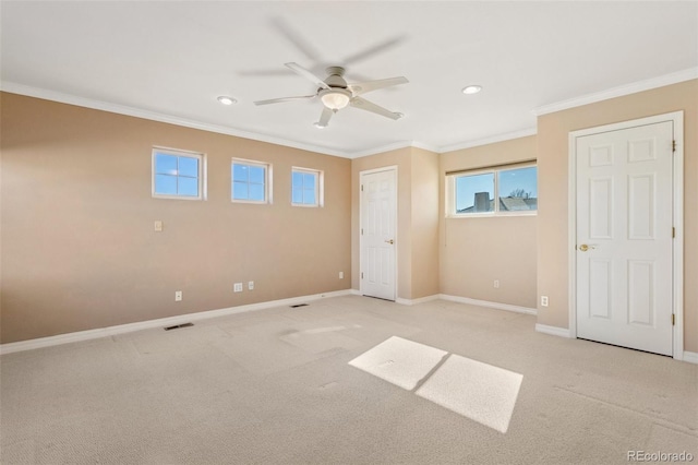 unfurnished bedroom with ceiling fan, light colored carpet, and ornamental molding