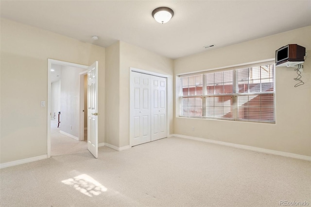 unfurnished bedroom featuring carpet flooring and a closet