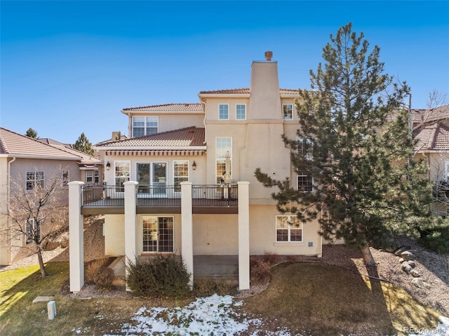 back of property with a balcony