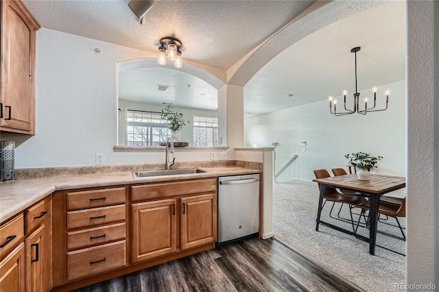 kitchen with sink, hanging light fixtures, a textured ceiling, stainless steel dishwasher, and dark hardwood / wood-style floors