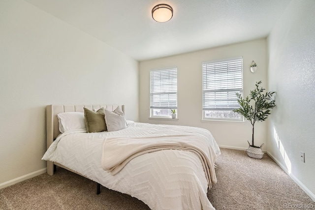 bedroom featuring carpet and baseboards