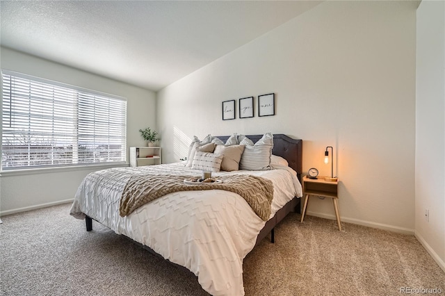 bedroom featuring vaulted ceiling, baseboards, and light colored carpet