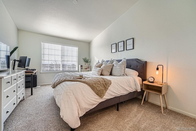 bedroom featuring light carpet, vaulted ceiling, a textured ceiling, and baseboards