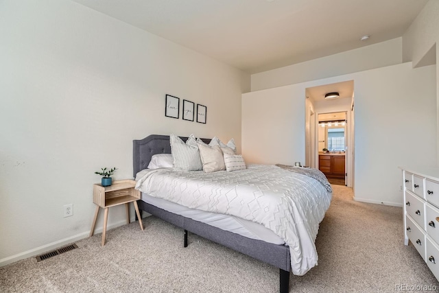 bedroom with visible vents, light carpet, and baseboards