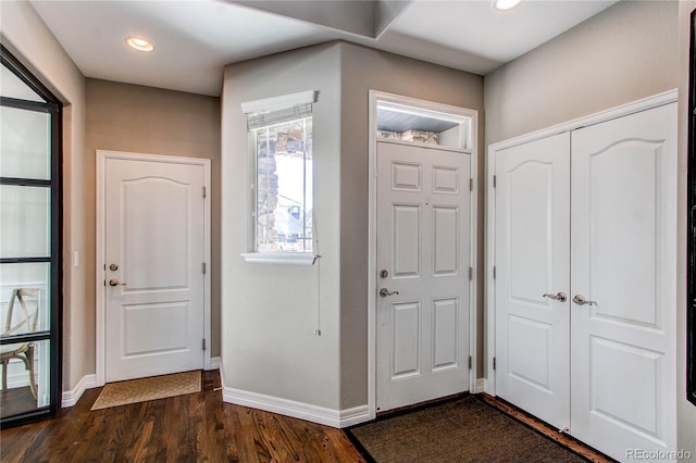 entrance foyer with dark wood-style floors, baseboards, and recessed lighting