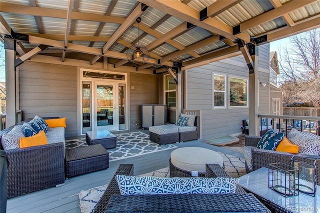 wooden terrace with an outdoor living space