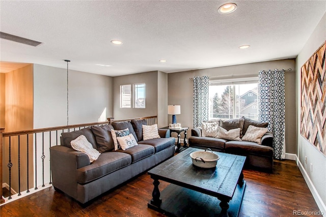 living room with recessed lighting, visible vents, a textured ceiling, wood finished floors, and baseboards