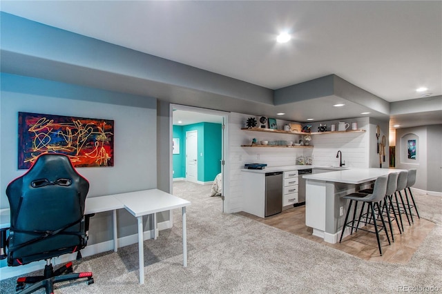 interior space featuring a breakfast bar, arched walkways, open shelves, light countertops, and white cabinetry