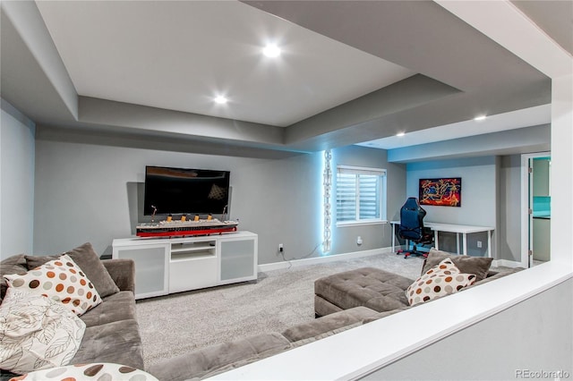 carpeted living area with a tray ceiling, baseboards, and recessed lighting