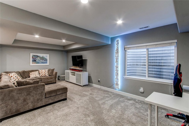 carpeted living area featuring a tray ceiling, visible vents, baseboards, and recessed lighting