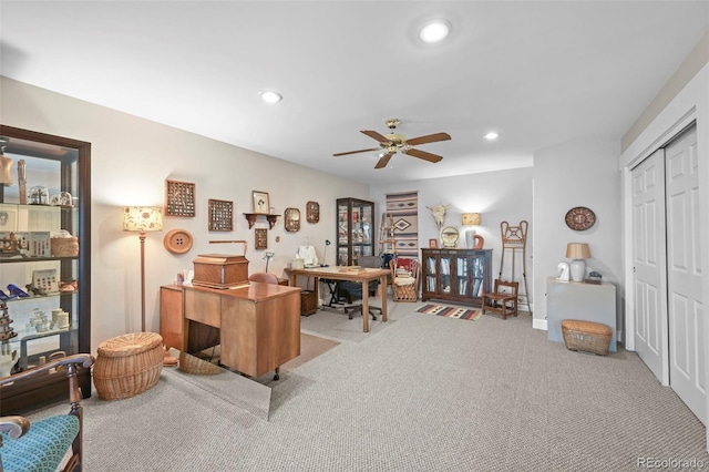 carpeted office featuring ceiling fan