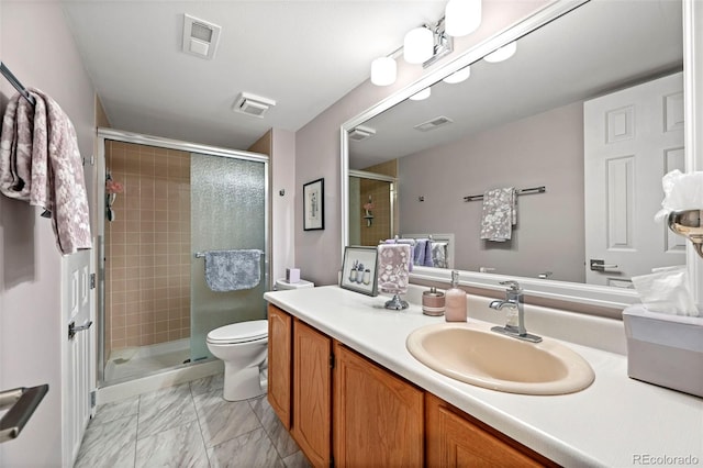 bathroom featuring vanity, an enclosed shower, and toilet