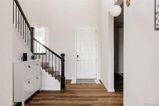 5840 Longs Peak St, Brighton, CO 80601 - entrance foyer with dark wood-style floors and stairway