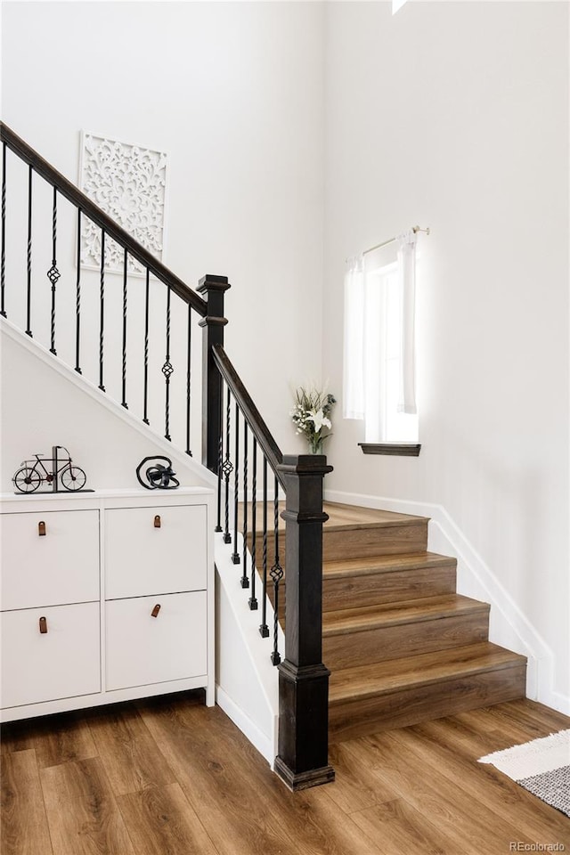 5840 Longs Peak St, Brighton, CO 80601 - stairs featuring wood finished floors and a towering ceiling