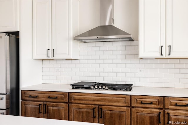 5840 Longs Peak St, Brighton, CO 80601 - kitchen with wall chimney exhaust hood, appliances with stainless steel finishes, white cabinets, light countertops, and tasteful backsplash