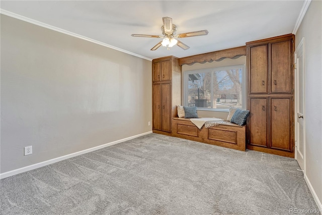 unfurnished room with ornamental molding, light colored carpet, and ceiling fan