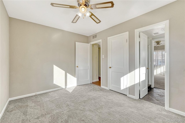 unfurnished bedroom with light carpet and ceiling fan