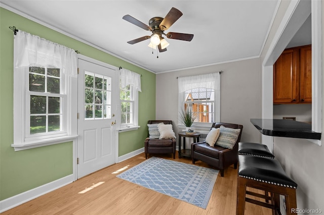 1033 Estes St, Lakewood, CO 80215 - sitting room with crown molding, light wood-type flooring, plenty of natural light, and ceiling fan