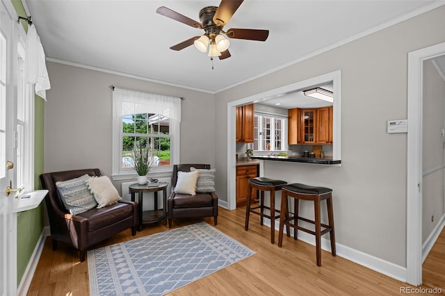 1033 Estes St, Lakewood, CO 80215 - sitting room featuring light wood-style flooring, ornamental molding, and ceiling fan